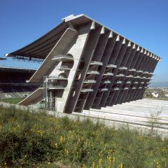 Exterior of Braga Municipal Stadium showing the angular concrete stand with stepped terraces and structural supports