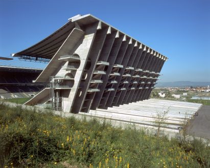 Exterior of Braga Municipal Stadium showing the angular concrete stand with stepped terraces and structural supports