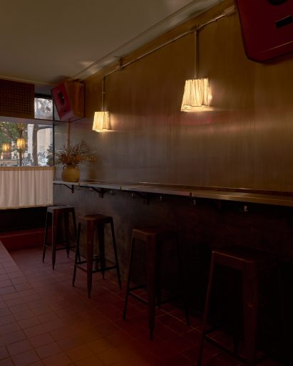 Sconces made from deadstock fabric mounted above a slender counter