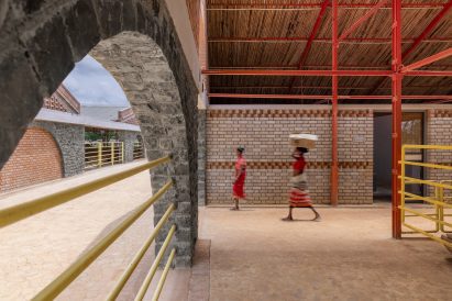 Red steel and stone structure of the cow house by Compartment S4