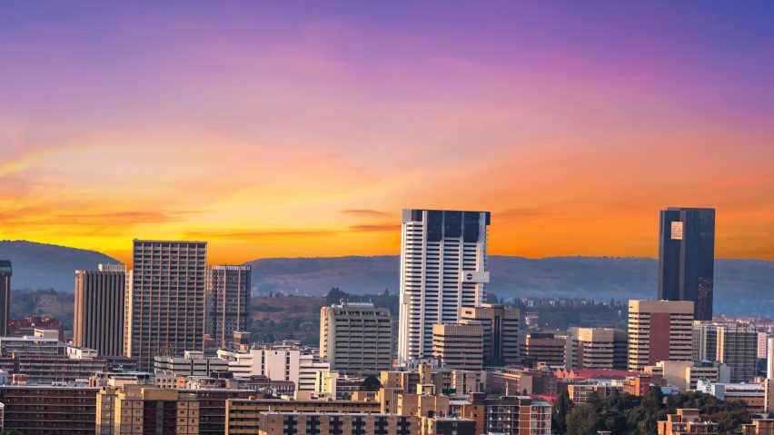 an image of a city against a sunsetting sky