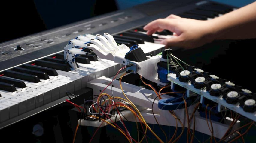 an image of a person's hand and a robot hand