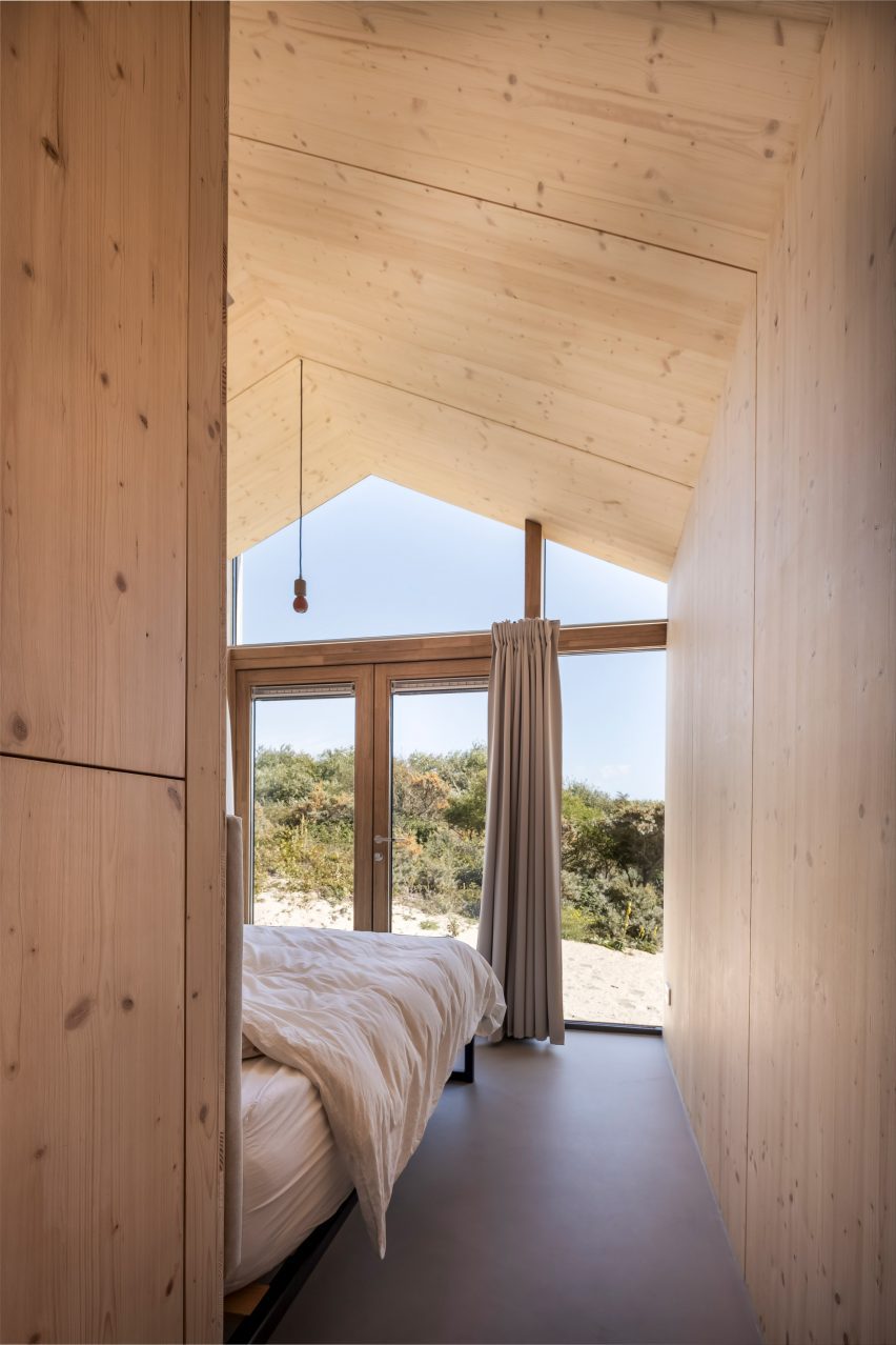 Master bedroom with wood panelling and large window