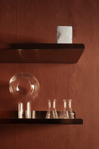 Red wall and shelves in En Doft store in Stockholm by All Matters Studio