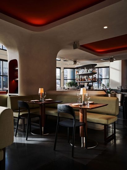 Limewashed elements curve over structural columns and soften angles