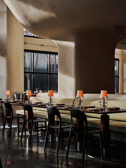 Pistachio fabric covers seats in an intimate dining area