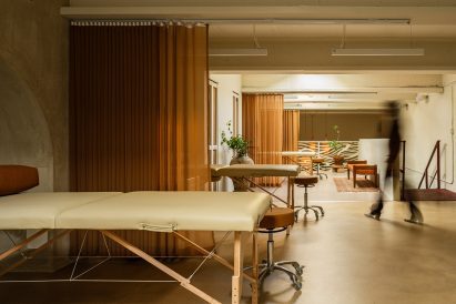 Tattoo stations divided by burnt orange curtains