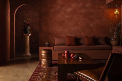 A communal lounge space drenched in rich pomegranate hues