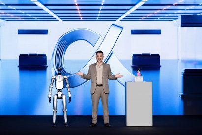 Photo of the Honor CEO on stage with a humanoid robot and the Robot Phone at Mobile World Congress 2026