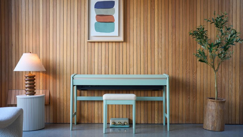 Celadon-green piano against brown wall