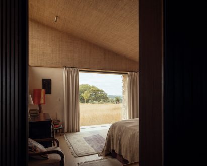 Bedroom of Rammed Earth House by Tuckey Design