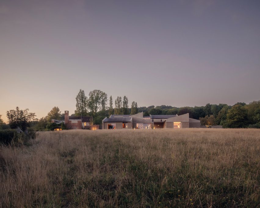 Night view of Rammed Earth House by Tuckey Design