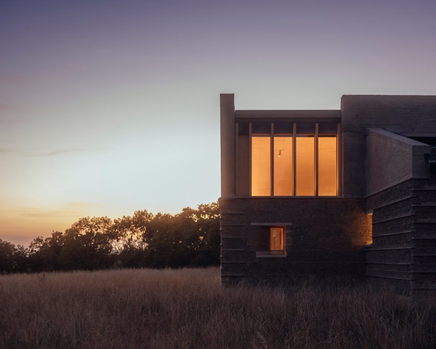 Night view of Rammed Earth House by Tuckey Design