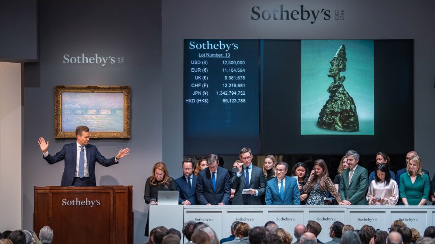 people sitting at an art auction