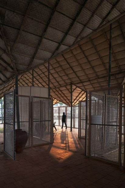 Gridded bamboo ceiling in beach building with dried grass mats.