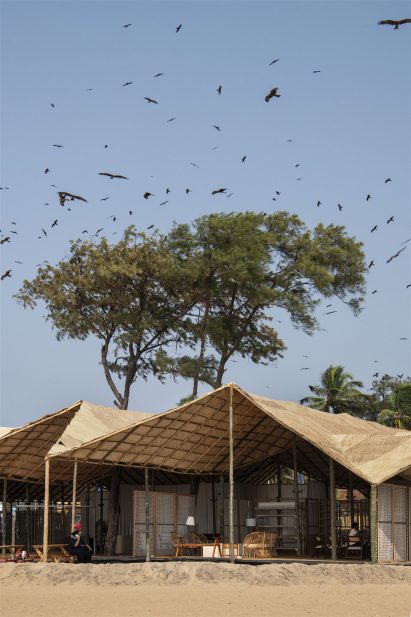 Bamboo canopy above a seating area, which faces the sea.
