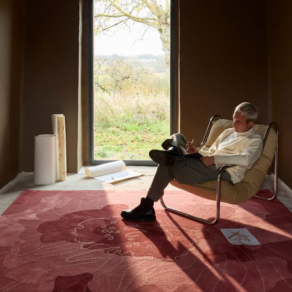 Photo of person sat on a chair writing