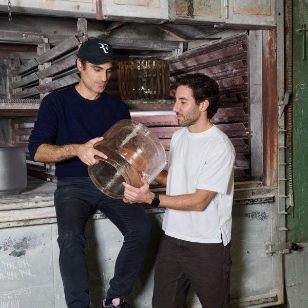 People holding glass design object
