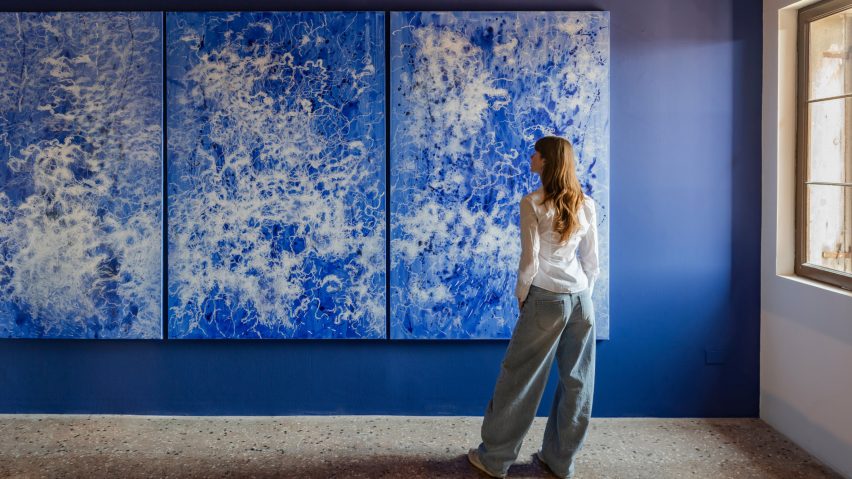 Photograph of person in front of exhibition display