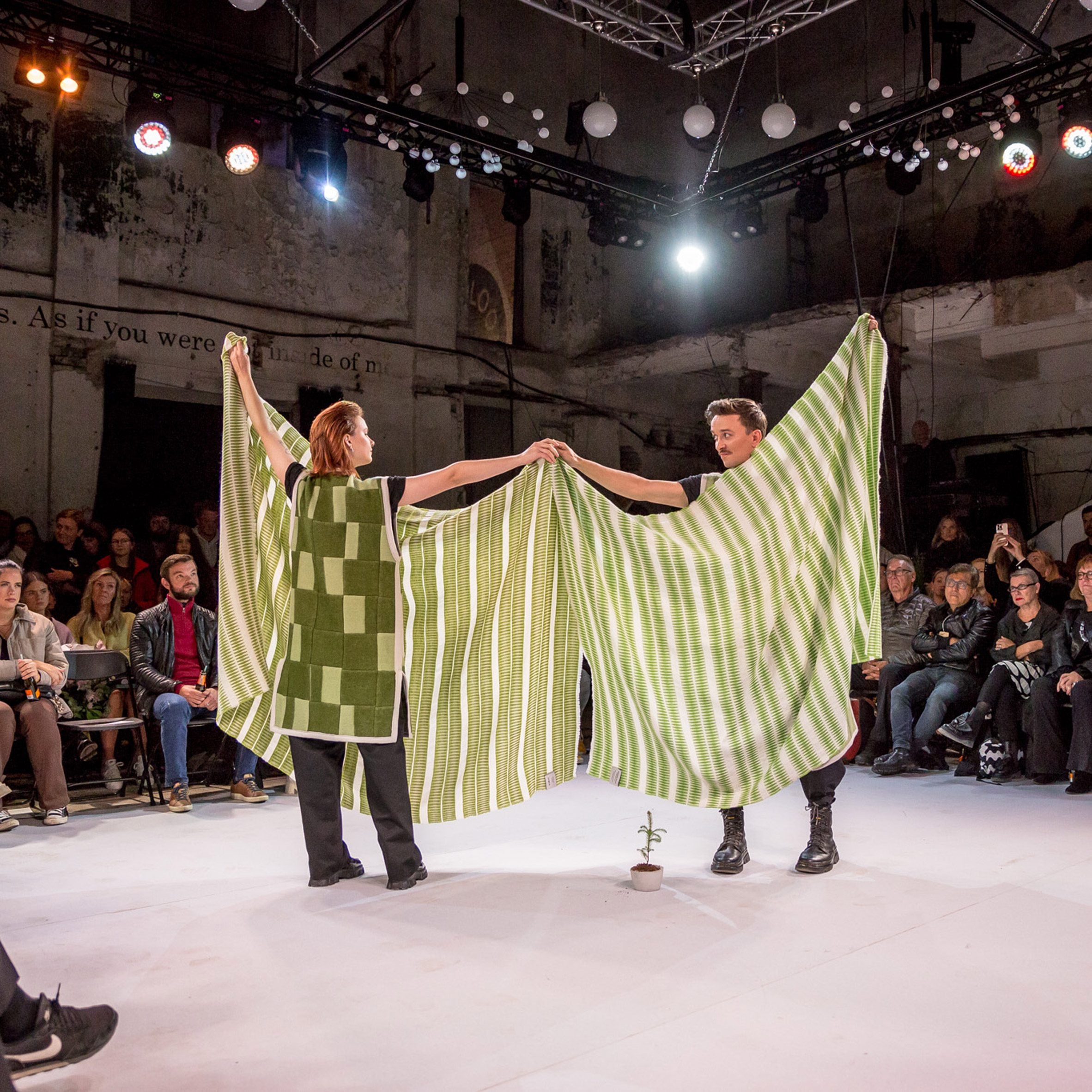 Photo of two people wearing and holding fabric