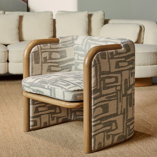 Chair with wood frames and patterned upholstery with neutral tones