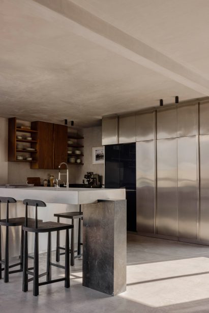 Kitchen with stainless steel storage doors and smaller walnut cabinets