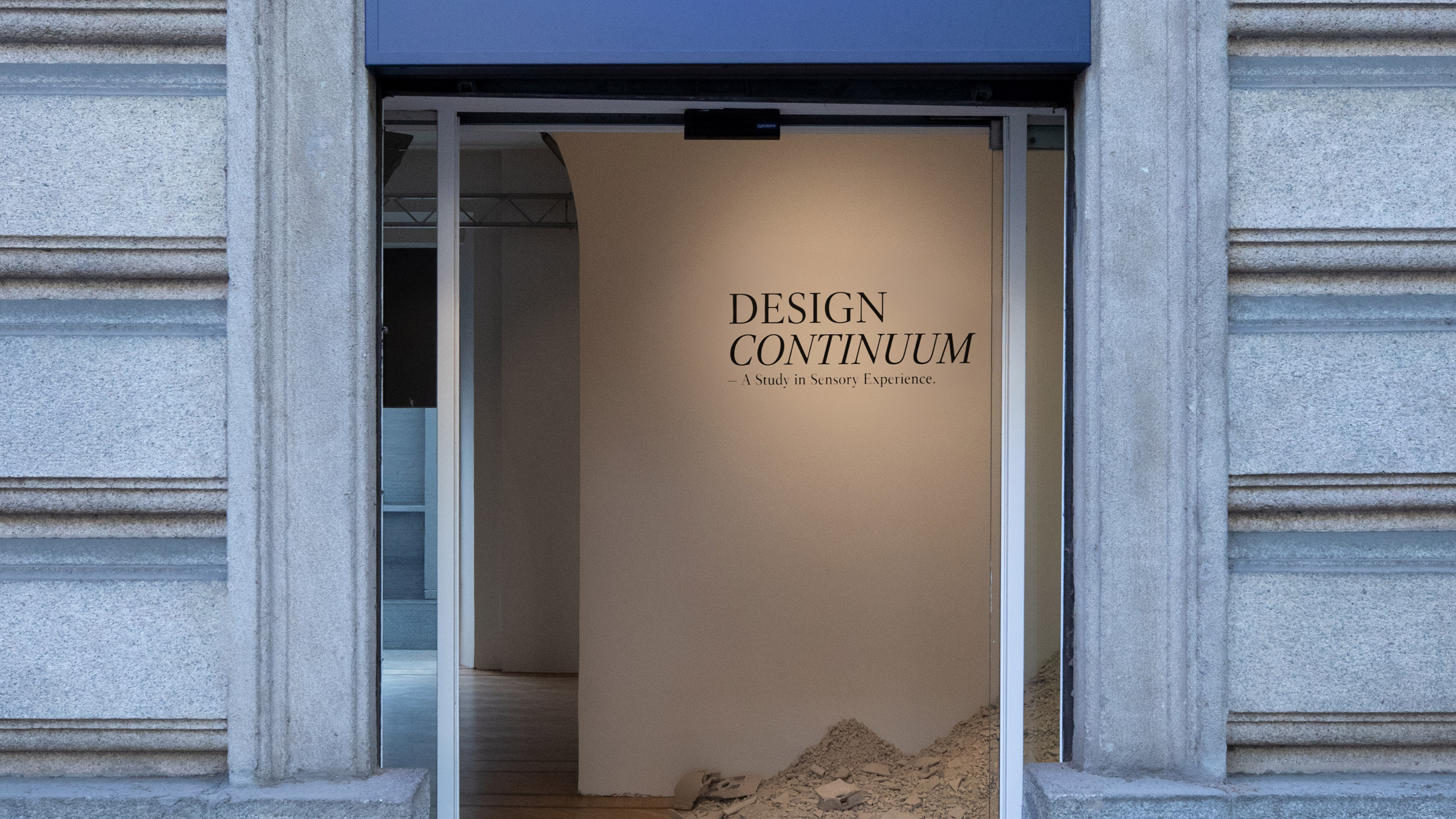 Entrance to an exhibition space with Design Continuum text on a wall