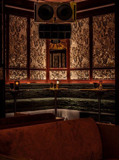 Green-hued banquettes within Dragon-i