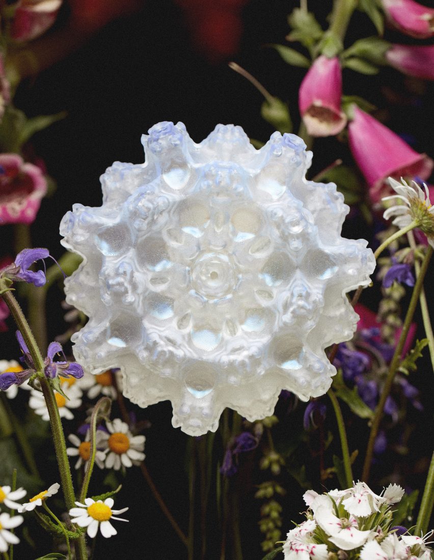 A photo of a Faux Flora prototype showing a shimmering white abstract fractal form sitting within a bouquet of flowers