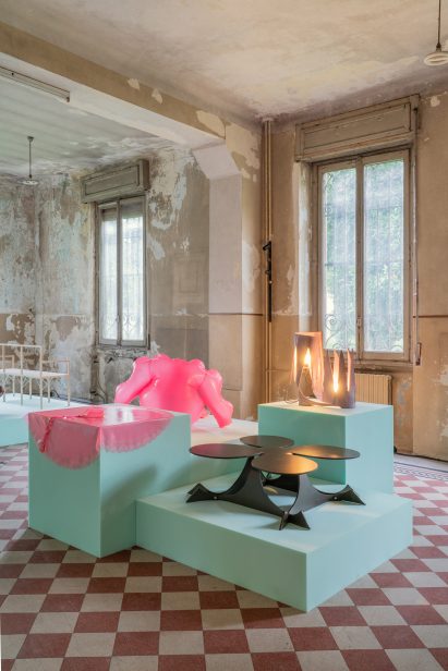 Photo of hot pink inflatable garments and a sculptural black metal table in the House of Creatures exhibition