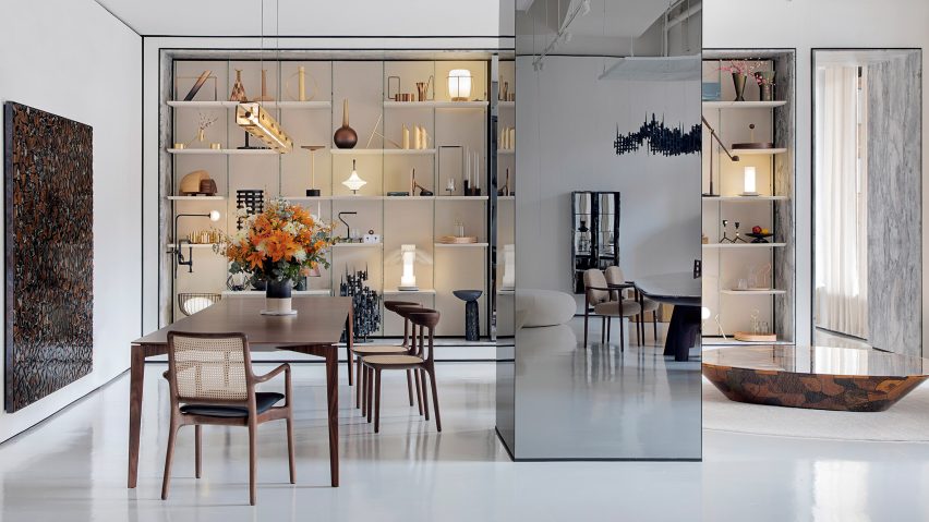 A furniture showroom with seating and lit display shelves