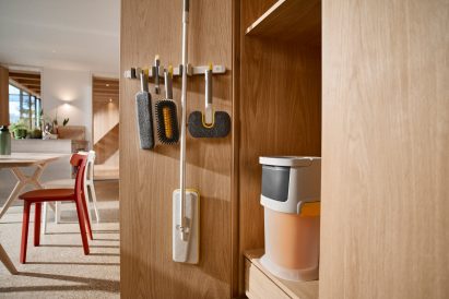 UltraClean system with interchangeable cleaning heads mounted on a wall storage rack