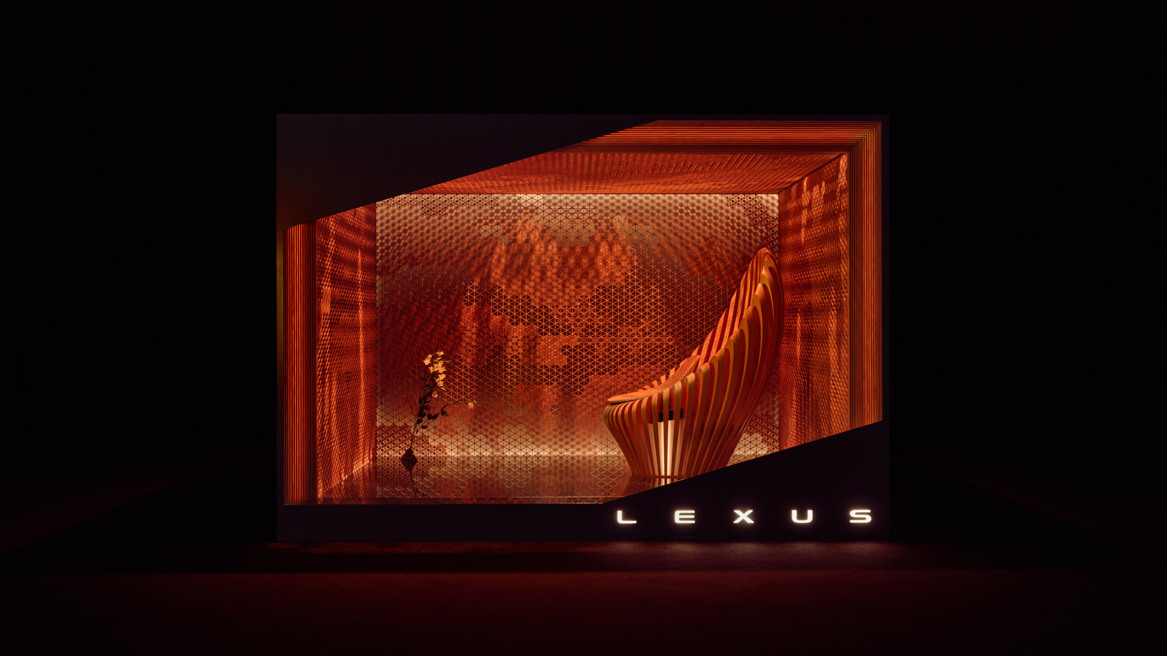 Amber-toned installation with textured surfaces and curved seating inside a glowing enclosure