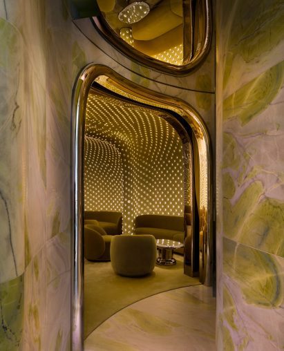 A marble-lined passage leads to a hidden lounge