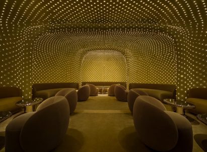 Tiny lights cover the walls and ceiling of a windowless lounge