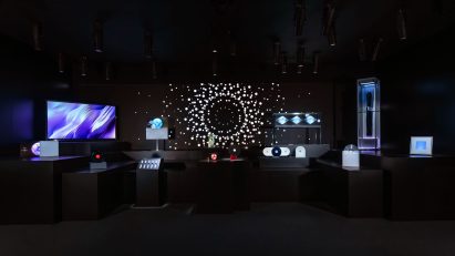 Dark room with illuminated screens, devices and a circular light installation