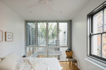 A white bedroom with oak floors