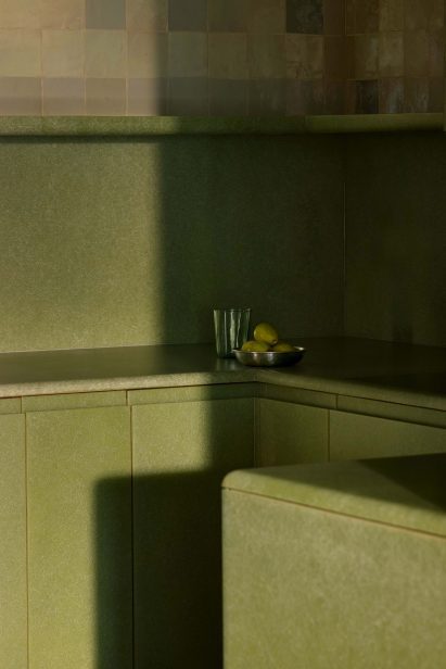 Detail of cabinets in an all-green fibreglass kitchen