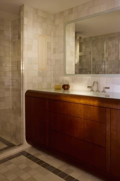 Walnut bathroom vanity surrounded by pearl-toned Moroccan tiles