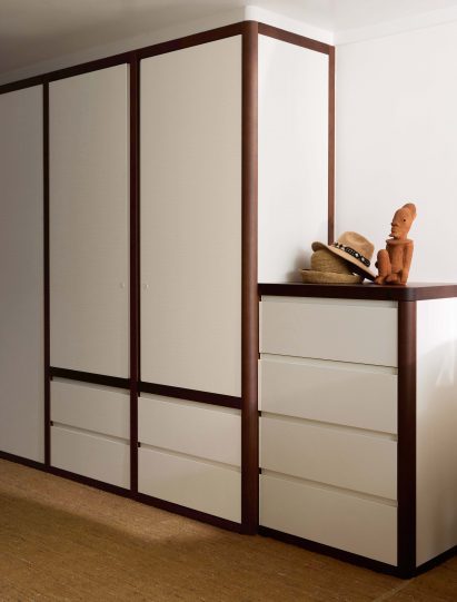Primary bedroom closet with rounded walnut outlines