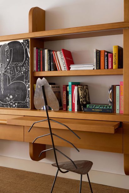 A fish-bone chair by Florence Provencer against a custom bookshelf