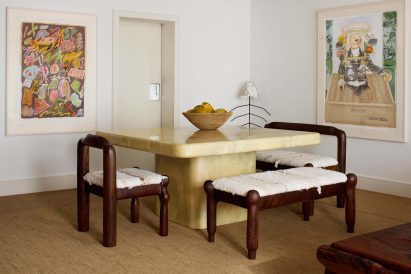 A goatskin dining table by Karl Springer paired with walnut chairs by Hagerman Studios