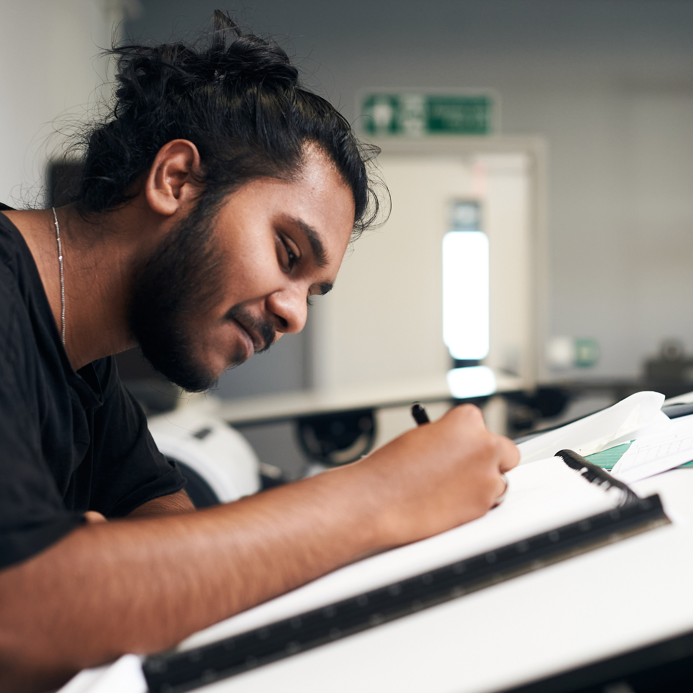 a person drawing at a desk