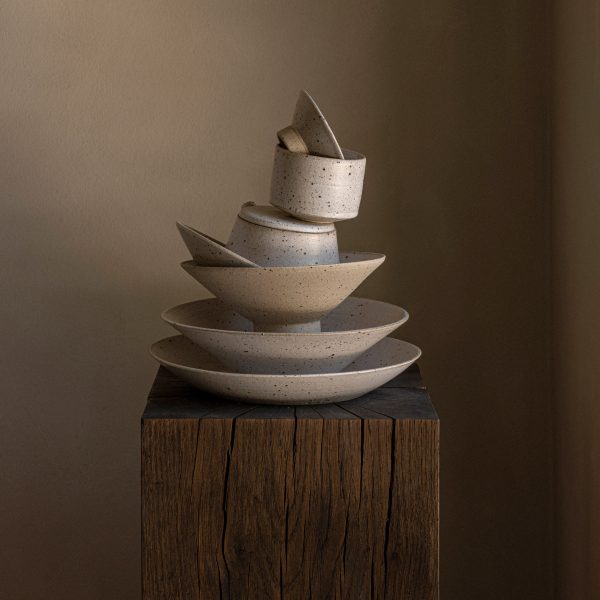 Photo of a pile of ceramics on a wooden table