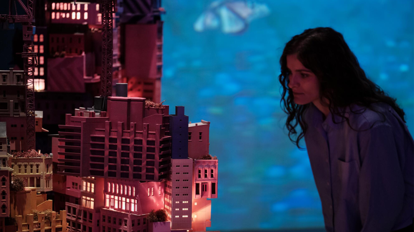 Exhibition visitor looking at model of future city