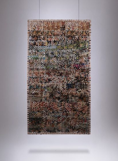 Image of a weaved rectangular material hanging from the ceiling.