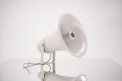 Image of a white speakerphone against a white background.