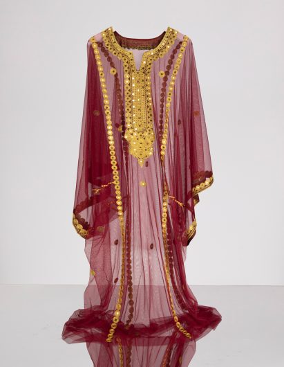 A photography of a hanging, decorative piece of clothing.