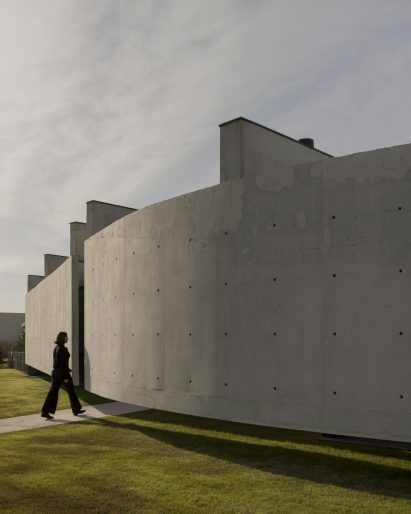 Casa Alba by Ademas Arquitectura, a concrete house with a wall for privacy