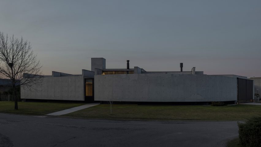 Casa Alba by Ademas Arquitectura, a concrete house with a wall for privacy